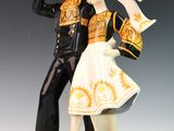 a figurine of a man and a woman dressed in costumes