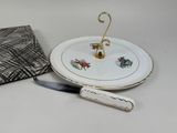 a plate with a knife on it next to a napkin