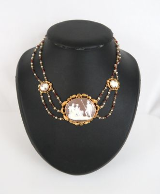 a close up of a necklace on a mannequin with a picture on it