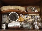 a wooden box filled with silverware and a brush