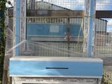 a bird cage with a window on top of it