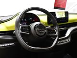 the interior of a car with a steering wheel and dashboard controls