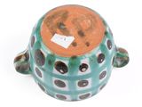 a small ceramic turtle with a tag on it ' s head