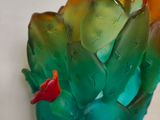 a glass vase with a flower inside of it