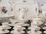 many plates and cups and saucers on the table