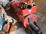 a red cart full of items on the floor
