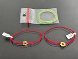 two red and green cords that are on a table
