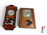 two clocks sitting next to each other on a white surface