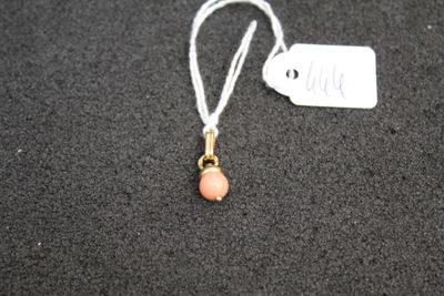 a small necklace with a pink bead on it