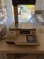 Une caisse balance et un tiroir caisse.