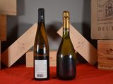 two bottles of wine sitting next to each other on a table