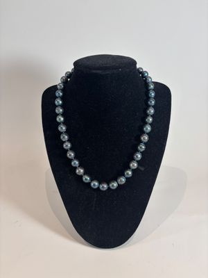 a close up of a necklace on a mannequin display