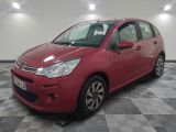 a red citrole is parked in a large room