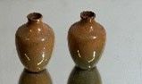 two vases that are sitting on a table