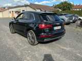 a black audi suv parked in a parking lot