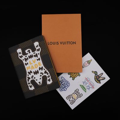 louis vuitton notebooks and stickers on a black surface