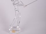 a glass figurine of a man holding a golf club