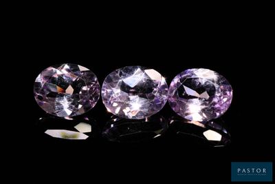 three purple sapphires on a black background