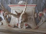 a deer head mounted on the mantle of a fireplace