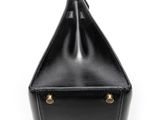 black leather handbag on a white background with a metal handle