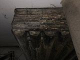 a picture of a very old looking column in a very dirty room