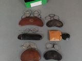 several pairs of glasses, a pair of scissors, a pair of glasses, a pair of glasses, a pair of glasses, a pair of glasses, and a