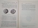 a book open to a page with a picture of a coin on it