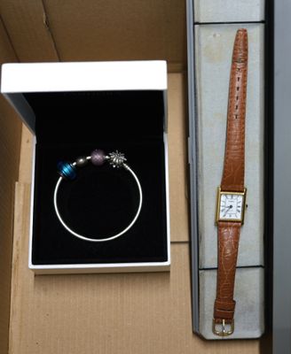 a box with a watch and a bracelet inside of it