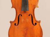 an old violin with a bow hanging from it ' s back