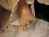 a close up of a person holding a baby doll