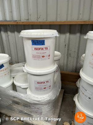 several buckets of paint are stacked on a pallet in a storage area