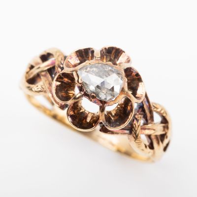 a close up of a gold ring with a diamond in the center