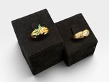 une paire de bagues en or et diamants présentées dans des coffrets en velours noir
