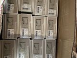 many boxes of electronic equipment in a box on the floor