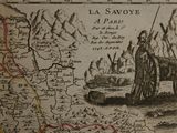 an old map of the region of la savoie, with a man standing in front of it