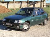 a green car that is parked on the side of the road