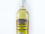 a bottle of whisky sitting on top of a white surface