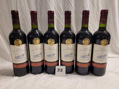 six bottles of wine are lined up in a row on a table