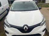 the front of a white car parked in front of a white van