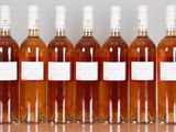 six bottles of wine are lined up in a row on a table
