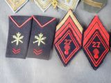 several different types of military uniforms are laid out on a table