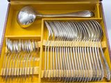 a yellow box with silverware in it on a white surface