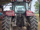 a tractor that is parked under a shelter