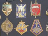 many different military badges displayed on a black surface