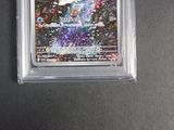 the card is in a clear plastic holder on a black surface