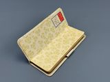 an open book sitting on top of a table next to a gray table