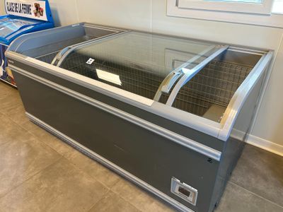a refrigerated freezer sitting in the corner of a room