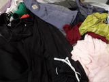 a pile of clothes that is sitting on the floor
