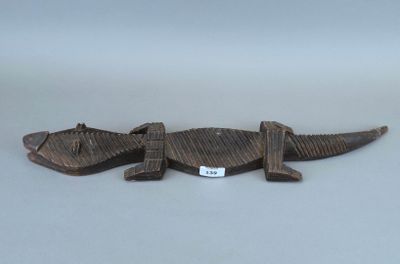 un petit lézard en bois posé sur une table