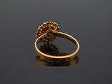 a close up of a gold ring on a black surface